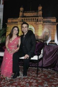 Priya & Manish Israni in front of a faux Gateway of India, Mumbai's famous landmark