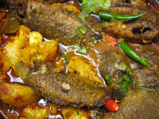 Bengali food centers around fish and this image shows Koi Fish with Cauliflower and Potato