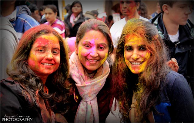 With color smeared faces, people celebrate Holi in Manhattan