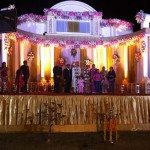 At an Indian wedding, couple and family gather on the stage