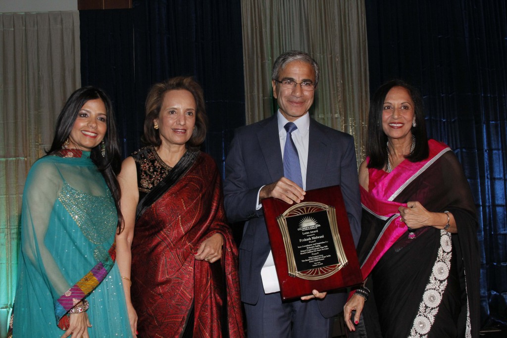 Lotus Award Honoree Prakash Melwani is flanked by emcee Tinku Jain, CHI co-founder Dina Pahlajani and CHI president Maya Rajani