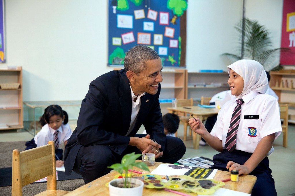 “The President talks with a young refugee at a Dignity for Children Foundation classroom in Kuala Lumpur, Malaysia. She was working on a painting.” (Official White House Photo by Pete Souza)