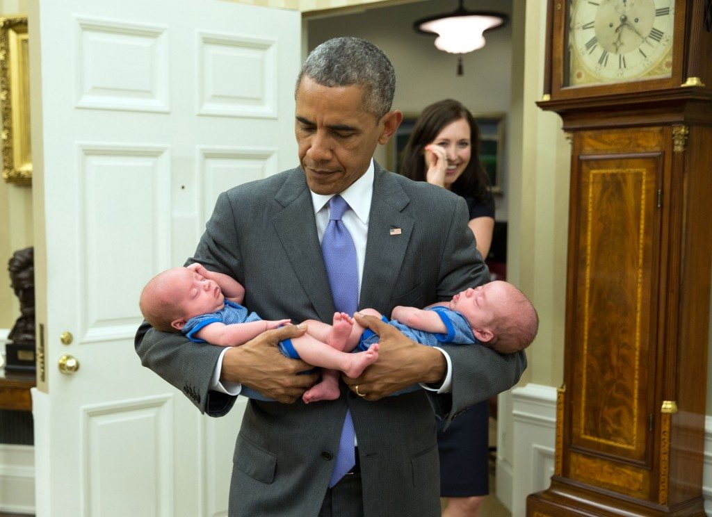 “The President carries the twin boys of Katie Beirne Fallon, Director of Legislative Affairs, into the Oval Office just a few months after they were born.” (Official White House Photo by Pete Souza)