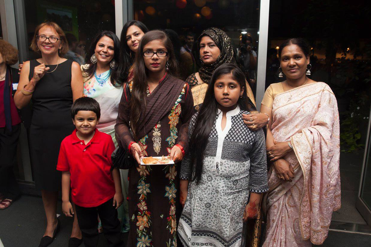 Surbhi Sahni with Alison Karasz, director of the Tiffin Project, immigrant women trainees and their families at a Sapna NYC fundraiser.