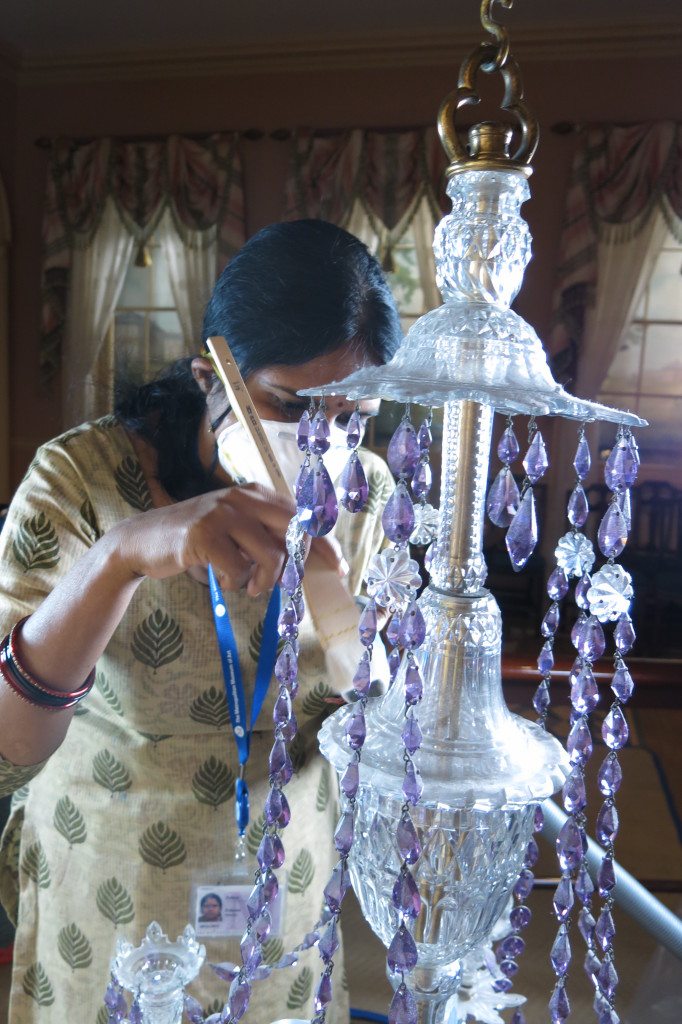 5.Kalpana—Salar Jung Museum, Hyderabad—Kalpana divided her time in the Museum between the Departments of Object Conservation and Textile Conservation. Here she is cleaning a glass chandelier with brass fittings in the American Wing’s Baltimore Room as part of the general maintenance of historic interiors and period rooms. This project allowed Kalpana to learn procedures regarding gallery work during visitors’ hours and the safe movement and rigging of works of art in fully installed galleries.