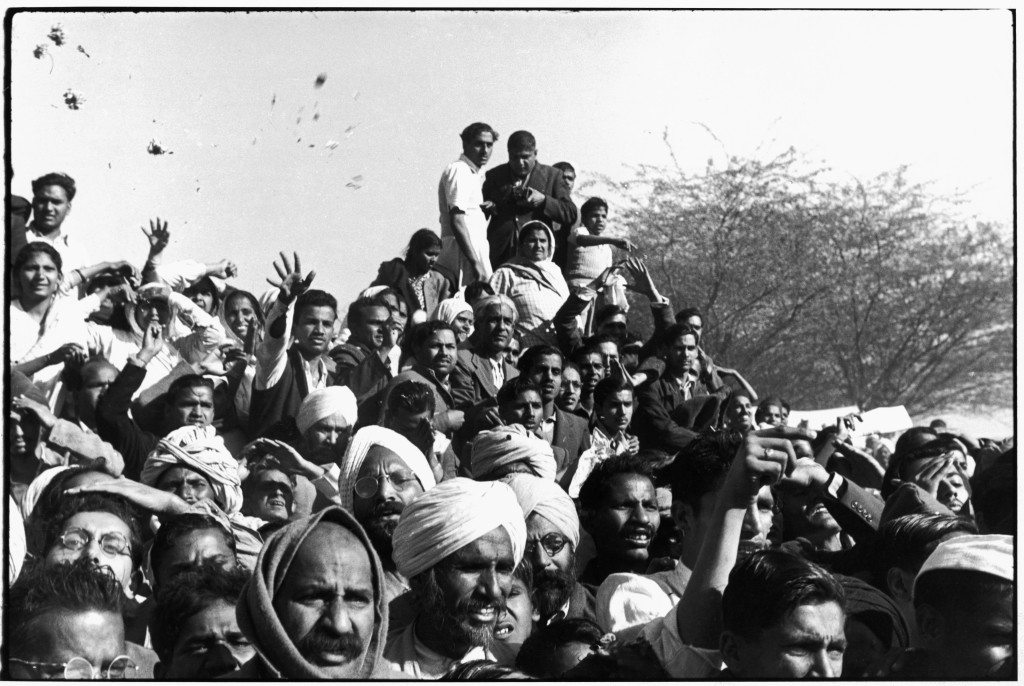 Delhi, India Gandhi's funeral. 1948. Crowds gathered between Birla House and the cremation ground, throwing flowers.