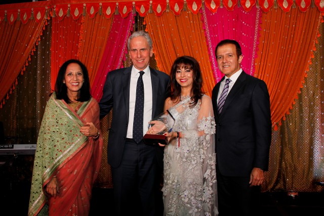 Bob Roth is presented the Making A Difference Award by Maya Rajani and Poonam and AJ Khubani of Telebrands, sponsor of the award.