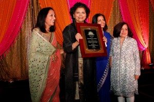 Chandrika Tandon receives the Lotus Award, flanked by Maya Rajani, Children's Hope India president, Tinku Jain, master of ceremonies, and Lavina Melwani, Children's Hope India co-founder.