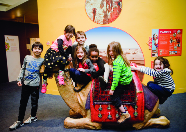 Children of all cultures ride on a camel
