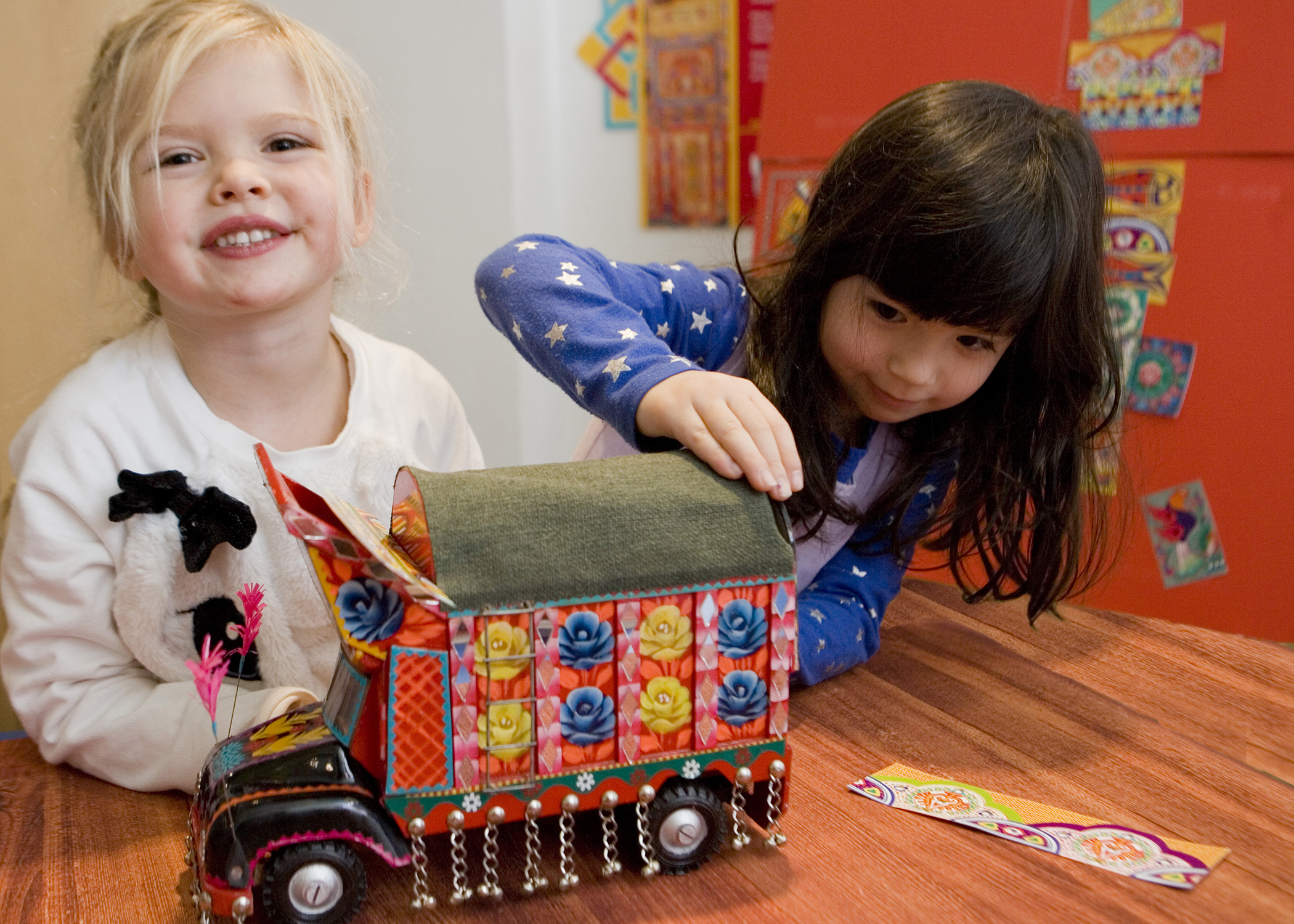 Children decorate a Pakistani truck with art