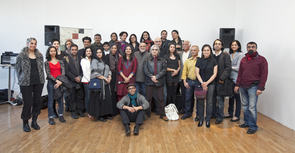 Diaspora artists who got new exposure and support through IAAC pose with noted artist Natvar Bhavsar