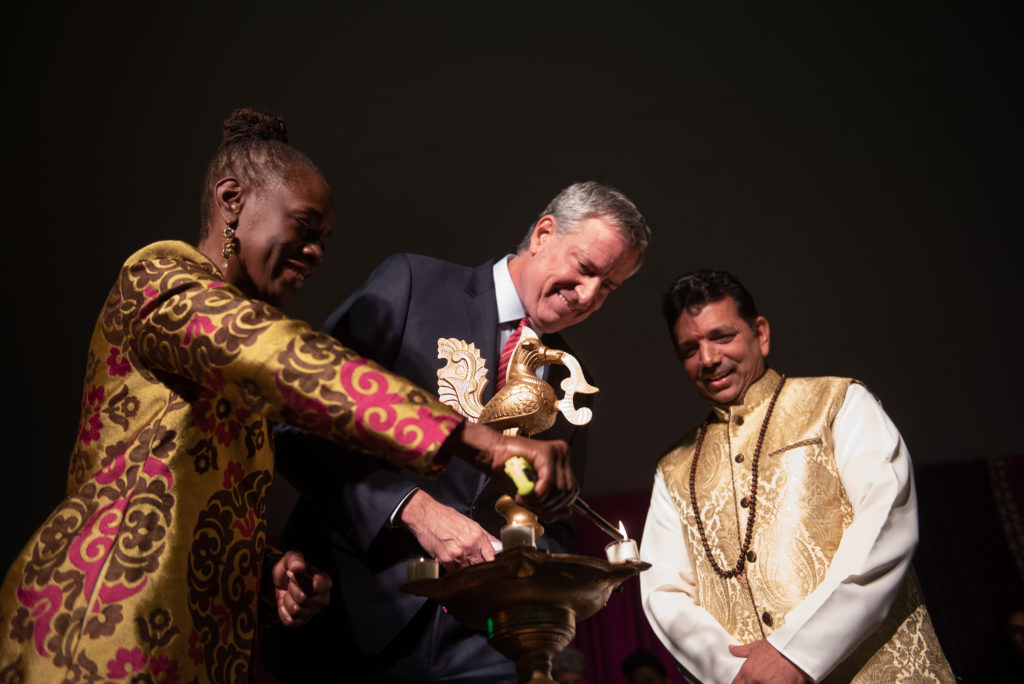 A Hindu priest officiates on the lighting of the lamp with Mayor Bill de Blasio and First Lady Chirlane McCray