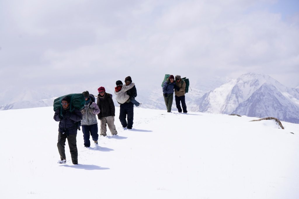 The escape party treks through the snow in Ritu Sarin & Tenzing Sonam’s The Sweet Requiem