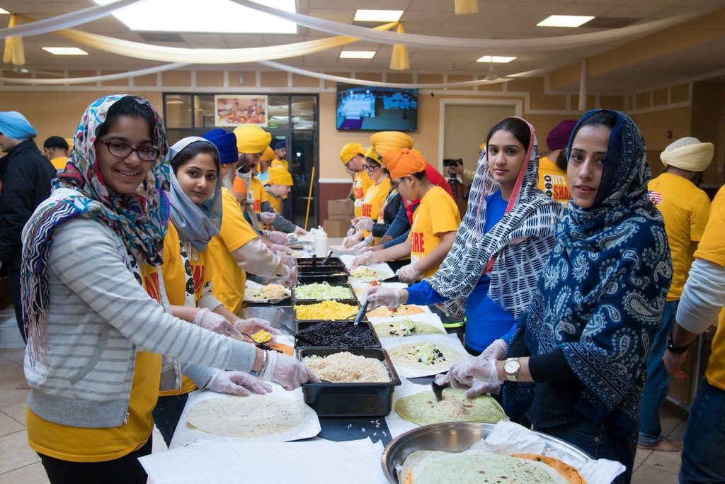 Volunteers from Let's Share A Meal prepare food for the homeless for Thanksgiving