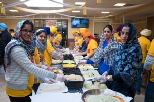 Volunteers from Let's Share A Meal prepare food for the homeless for Thanksgiving