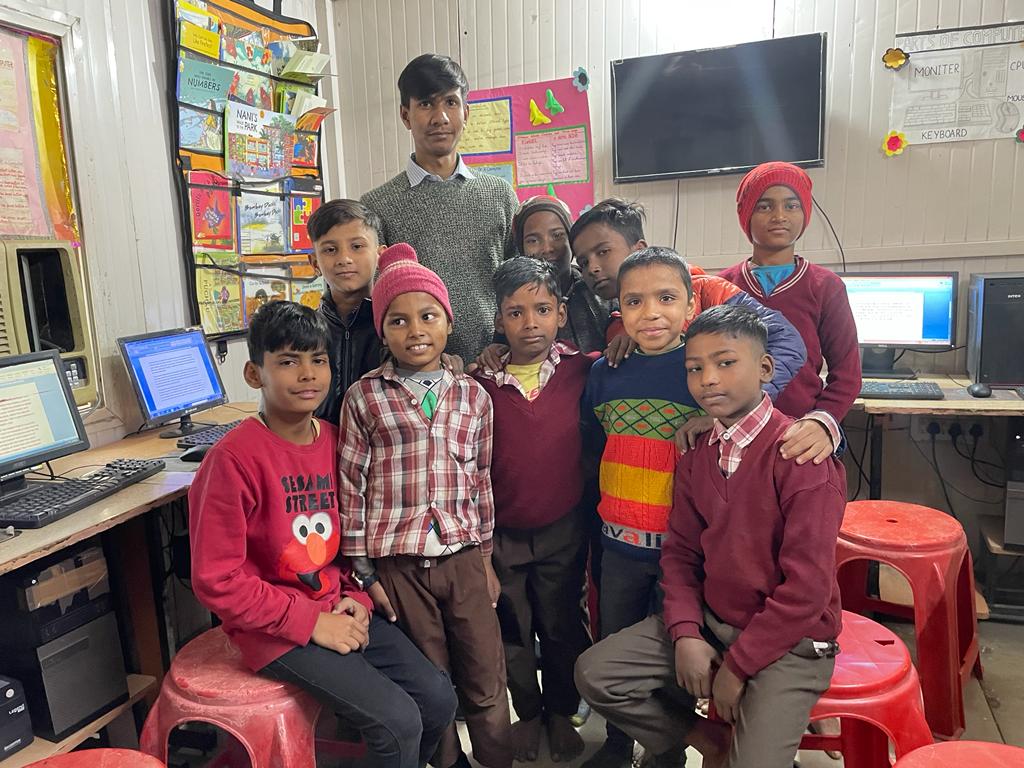 Children in the computer lab at CHI Prayas with their teacher