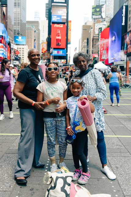 Family enjoying Yoga day in Times Square Summer Solstice